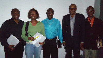 Left to Right: three attendees converse with Las Newman and Desmond Rogers, presenters at the Conference.